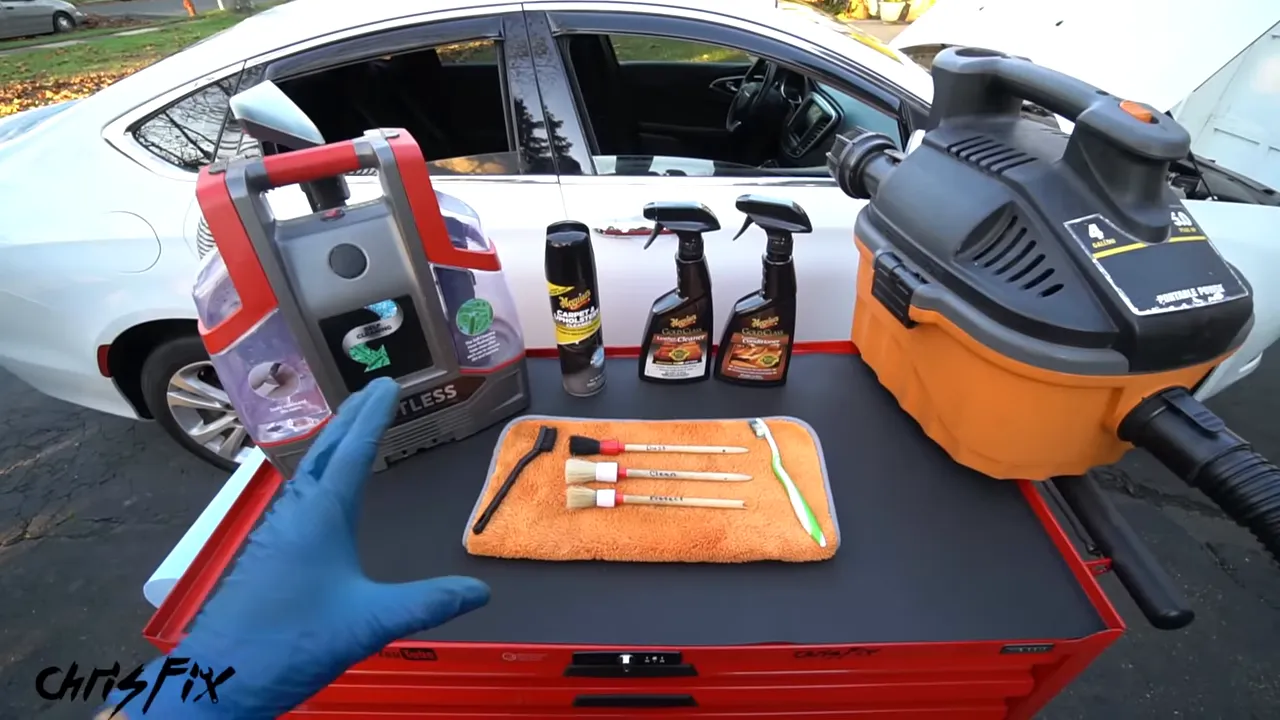 Extractor, shop vacuum, cleaning bottles, brushes, and microfiber towels on a tool cart