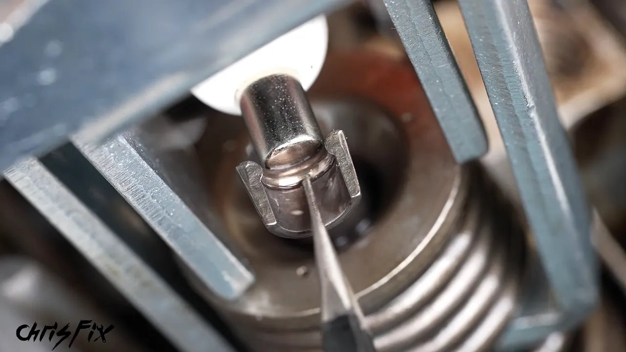 Close-up of a compressed valve spring with the split keepers exposed around the valve stem
