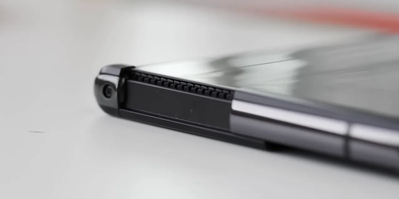 Close-up of the LG rollable phone edge showing exposed gear teeth and a sliding rail