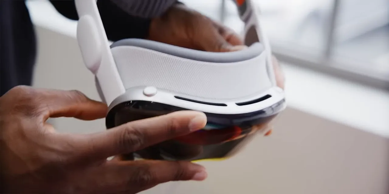 Close-up of the Vision Pro frame with a finger pointing toward its upper vents