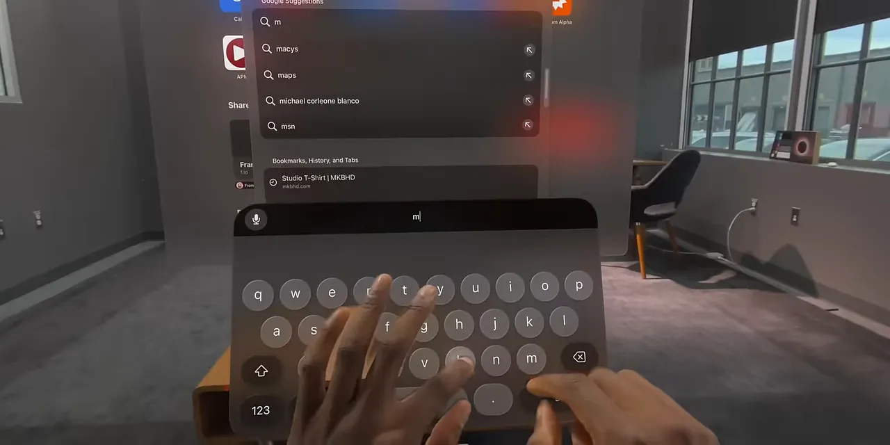 Hands reaching toward a floating keyboard beneath Safari in visionOS