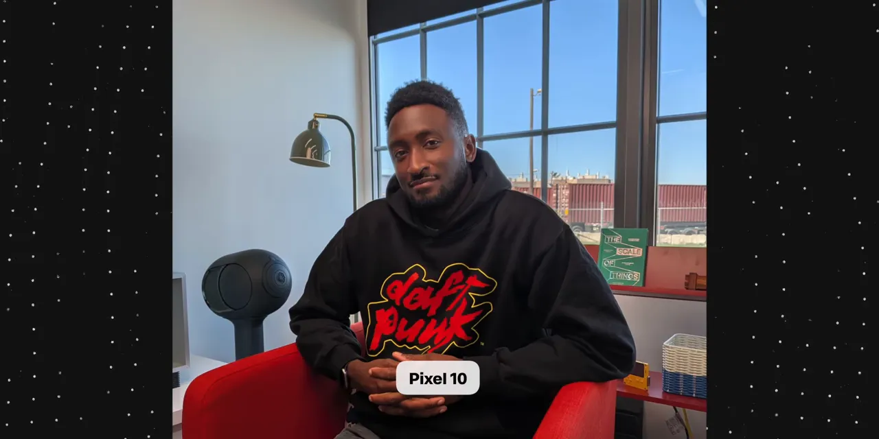 Pixel 10 photo of a man in a black hoodie seated in a red chair beside bright windows