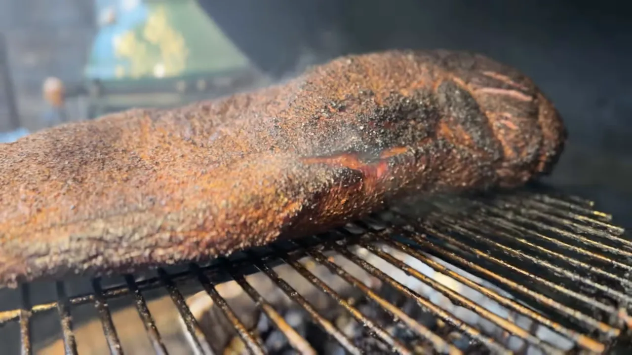 Close view of a brisket end on the raised rack with a darkened edge