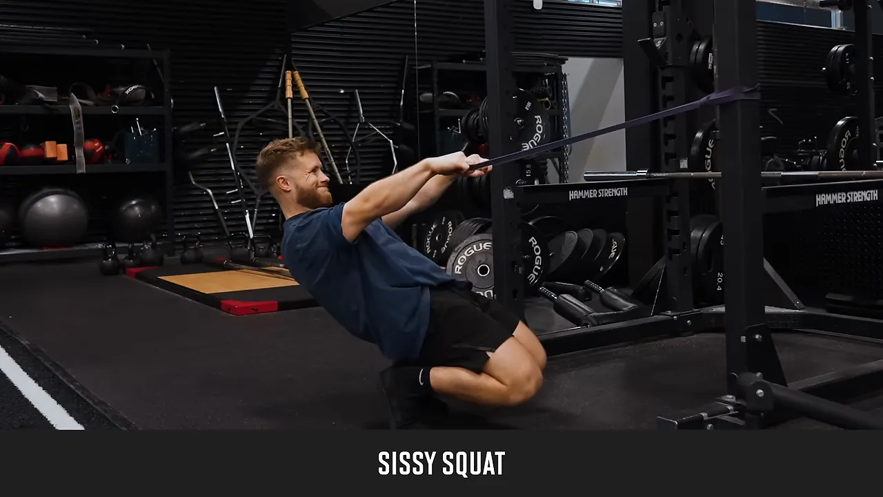 Lifter leaning backward in a deep sissy squat while holding a band attached to a rack