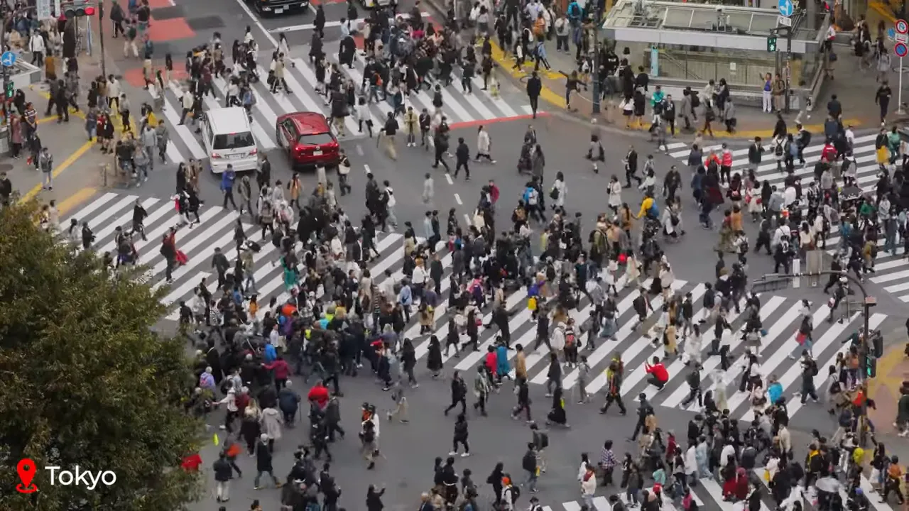 Aerial view of Shibuya Crossing in Tokyo filled with hundreds of pedestrians crossing in multiple directions