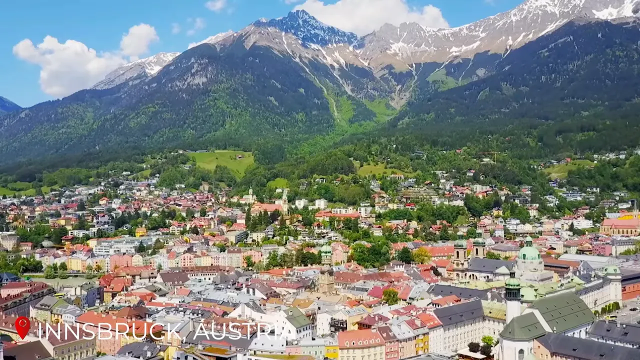 Panoramic view of Innsbruck with colorful old-town roofs and the Nordkette mountain range rising behind