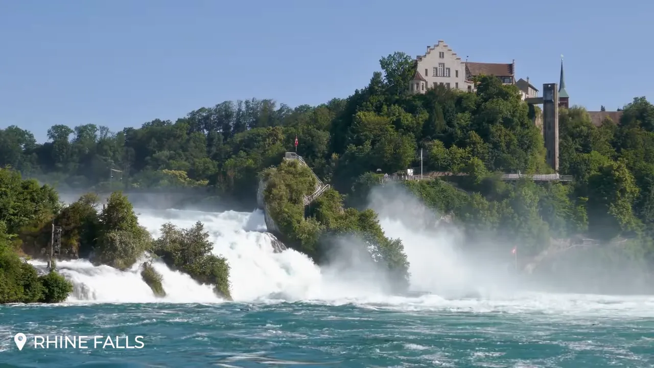 Close-up of Rhine Falls showing rock viewing platform, misty spray and Schloss Laufen
