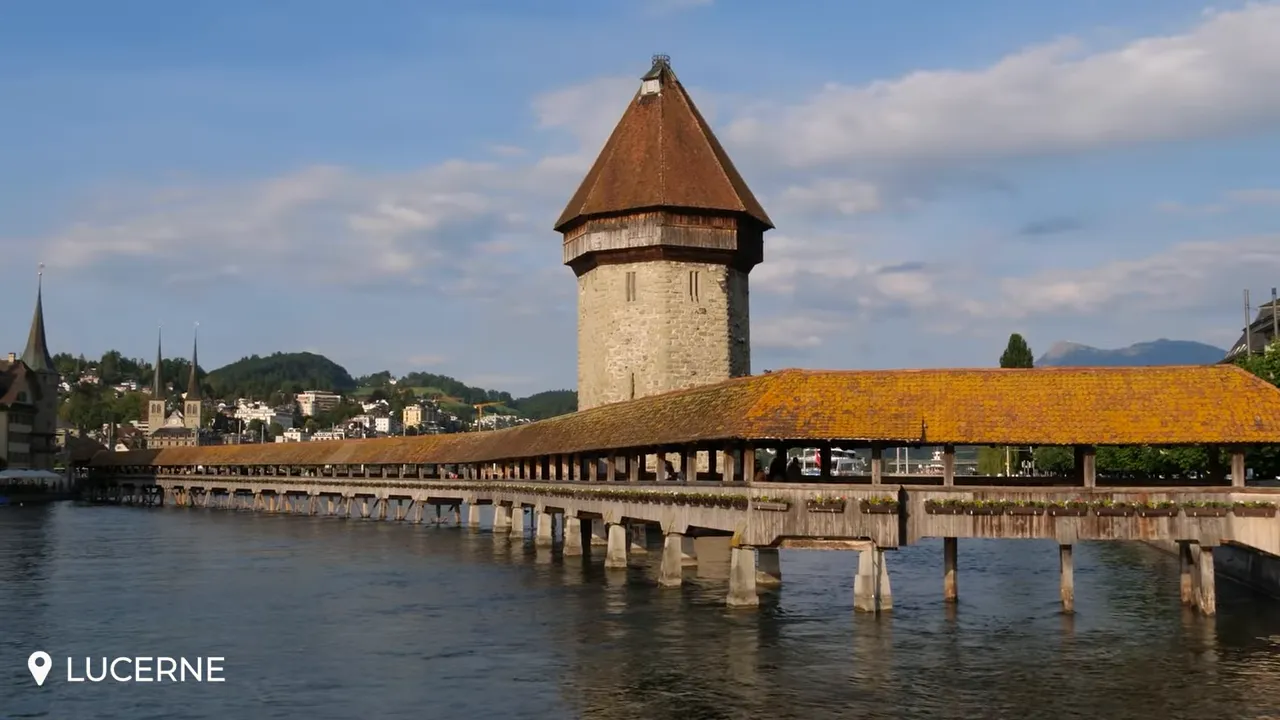 Close view of Lucerne's Chapel Bridge (Kapellbrücke) with the Water Tower and wooden covered walkway crossing the river.