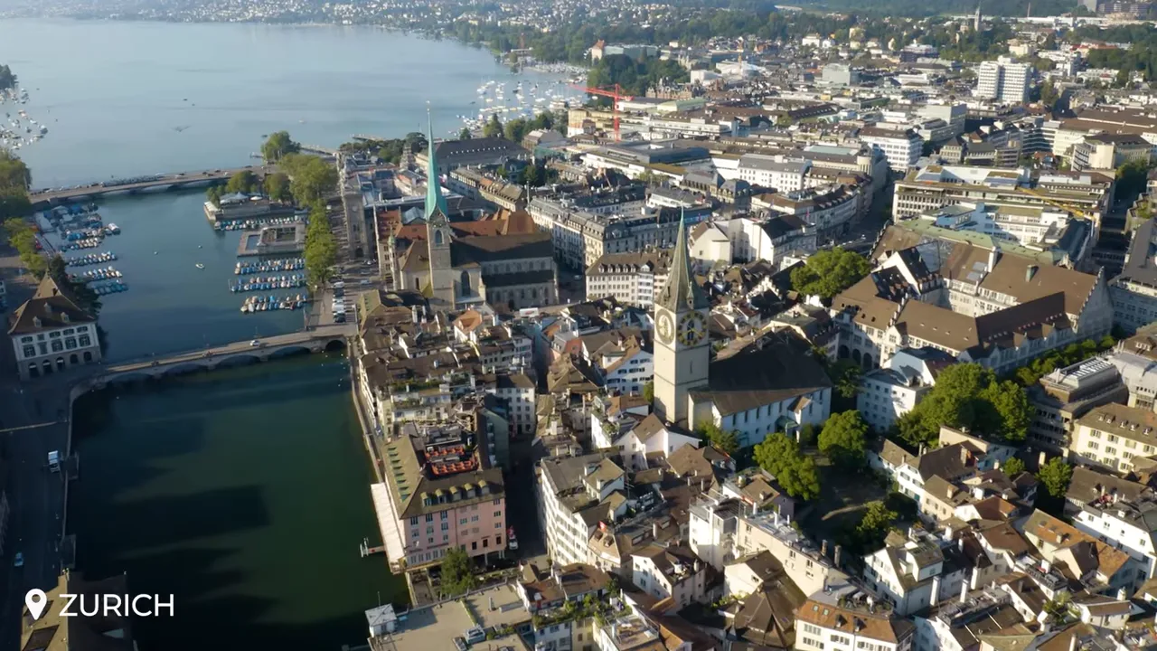 Aerial shot of Zurich city center with St. Peter's clock tower and Lake Zurich in the background