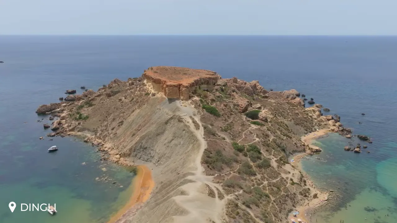Aerial view of Dingli Cliffs headland with limestone plateau, walking paths and turquoise sea