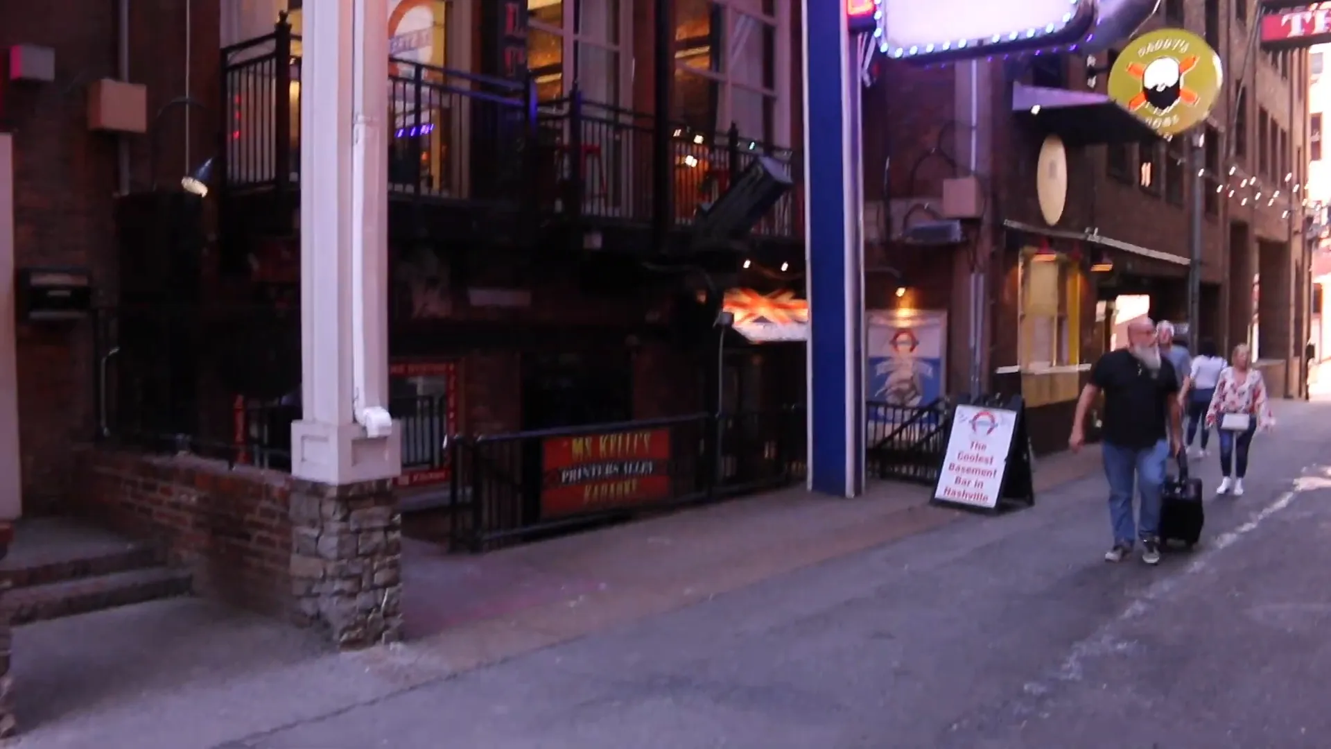 Printers Alley nighttime view with neon and small crowds