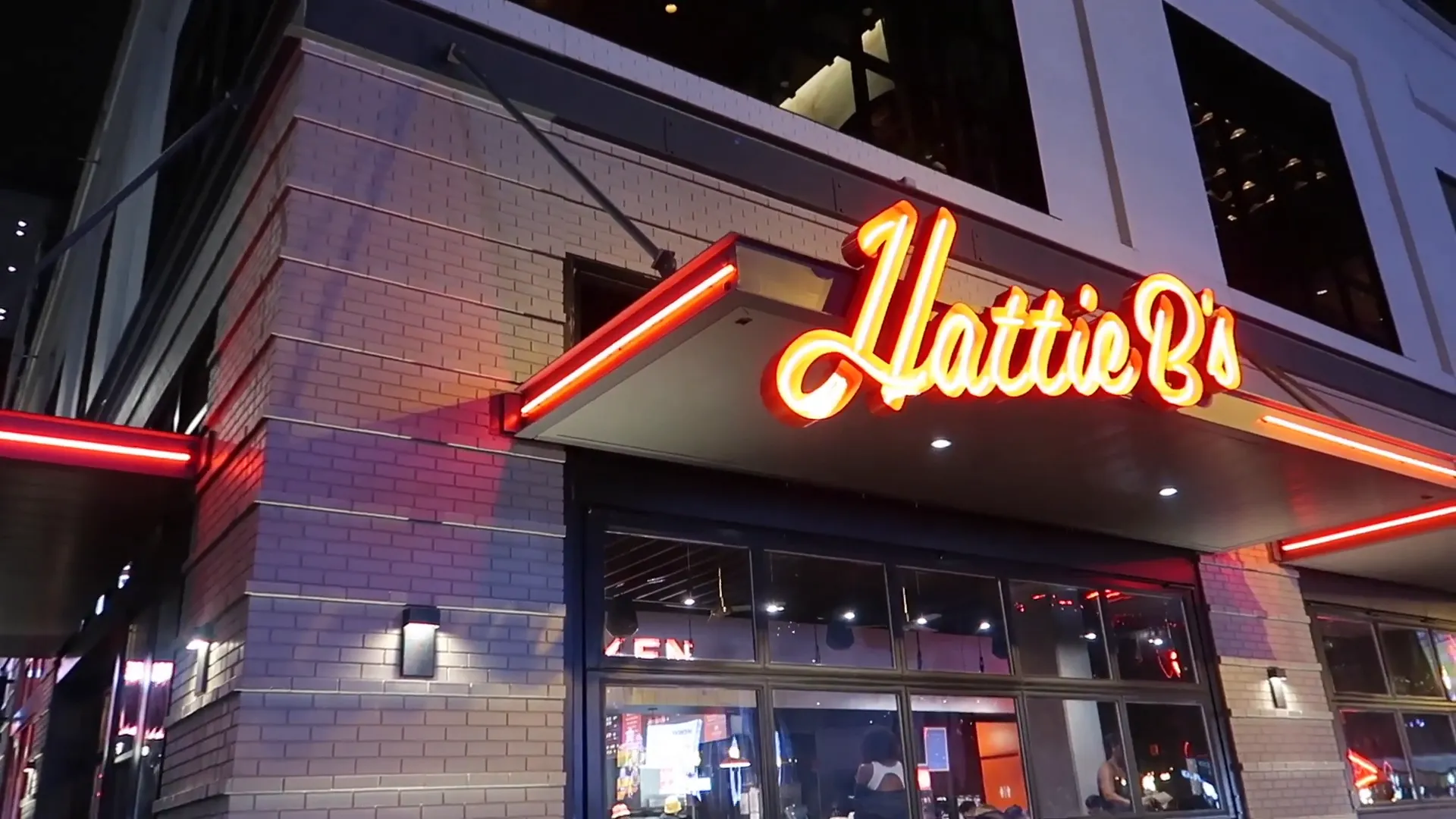 Hattie B's exterior on Broadway and nearby food hall entrance