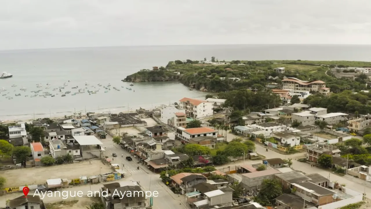 Wider aerial shot of Ayangue and Ayampe showing the sandy shore, moored boats, rocky headland and clustered seaside houses