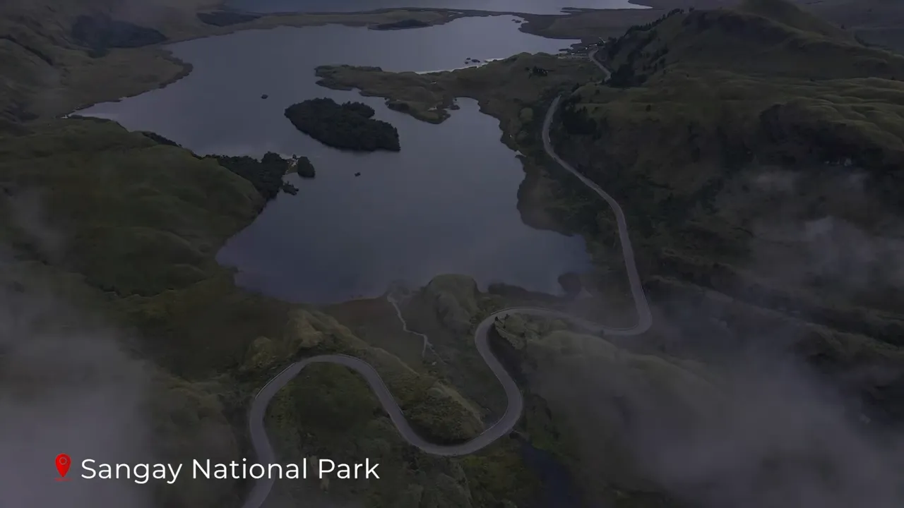 Aerial view of winding road, glacial lakes and mist‑shrouded paramo hills in Sangay National Park