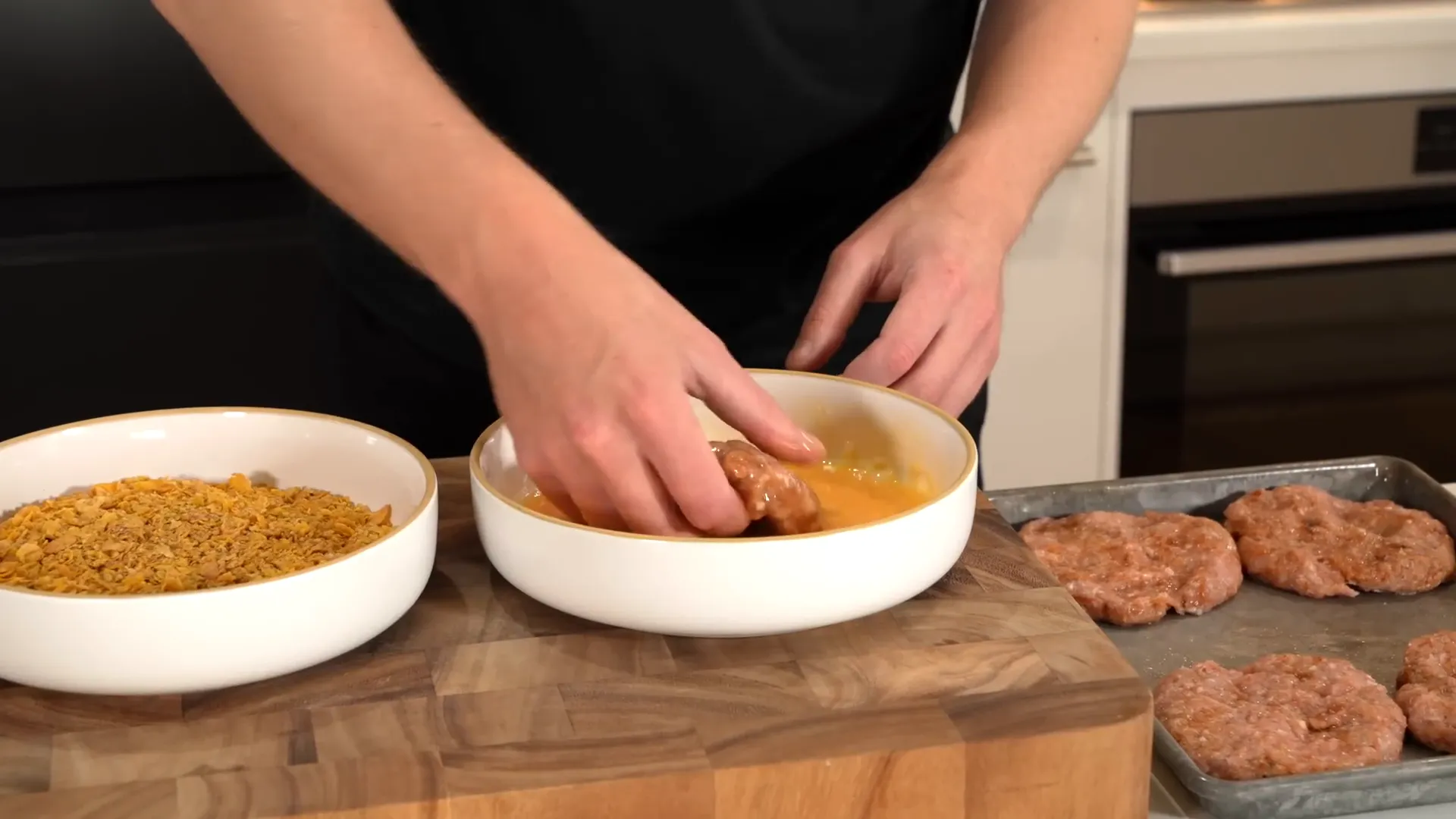 Coating chicken patties with cornflakes