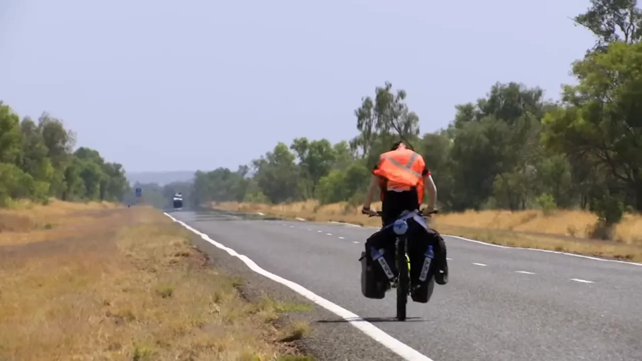 Cyclist on the remote sealed road