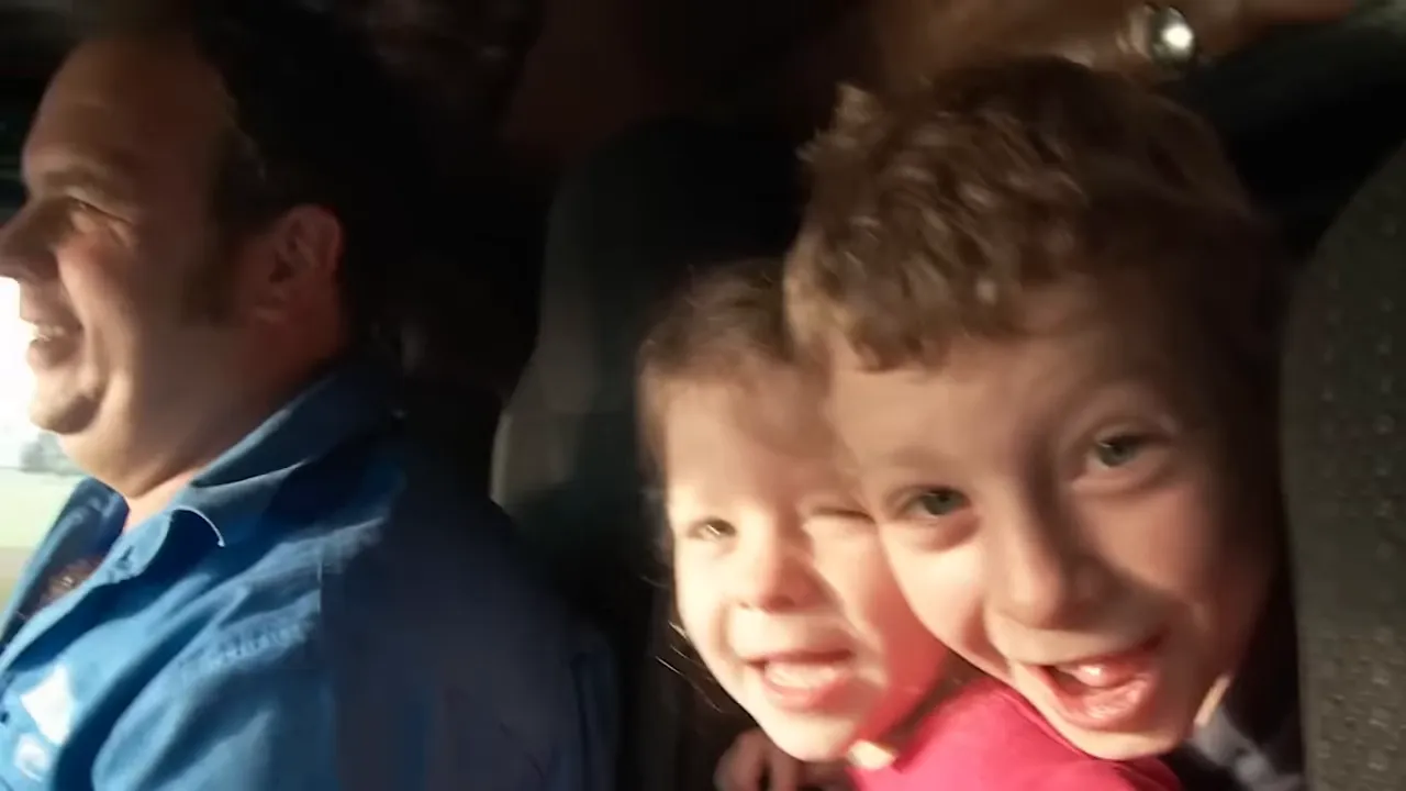Kids riding in the truck cabin with Dad on the road
