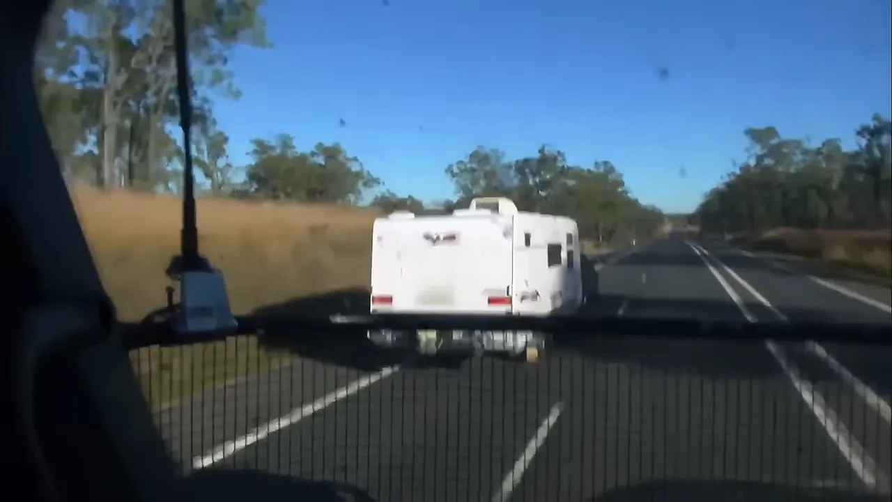 Long Outback highway with caravans