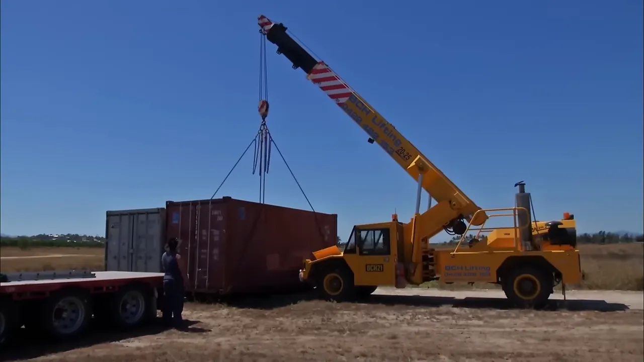Crane lifting a container onto Turbo's trailer