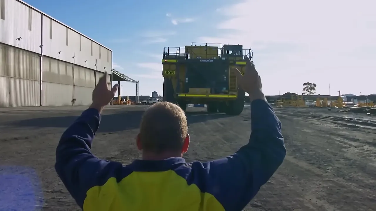 Reversing the dump truck onto the trailer — delicate alignment