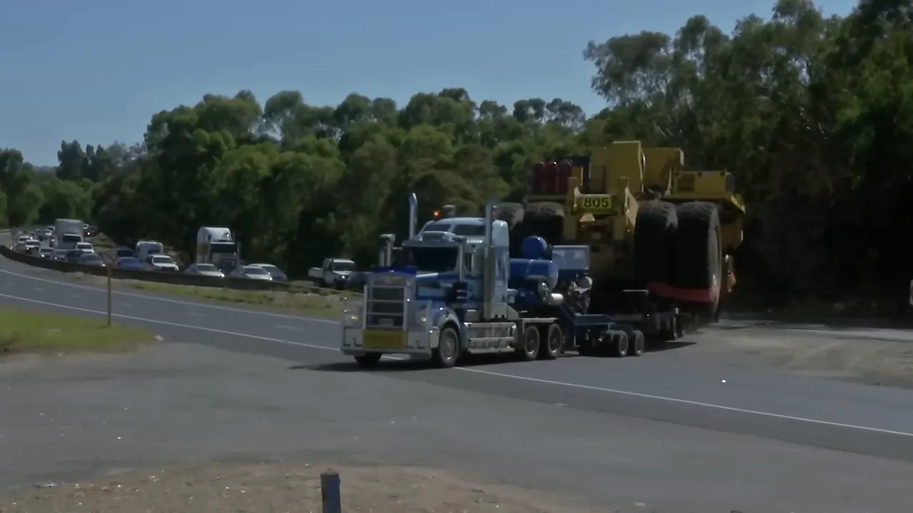 Pilots and traffic control closing Tonkin Highway for the oversize entry
