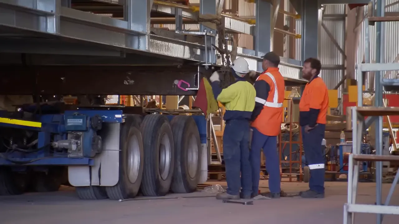 Drivers discussing chain arrangement on the load