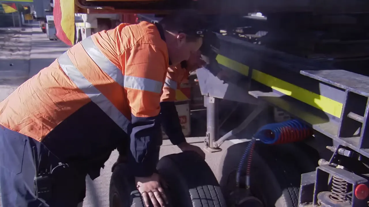 Overheated brake being cooled and checked