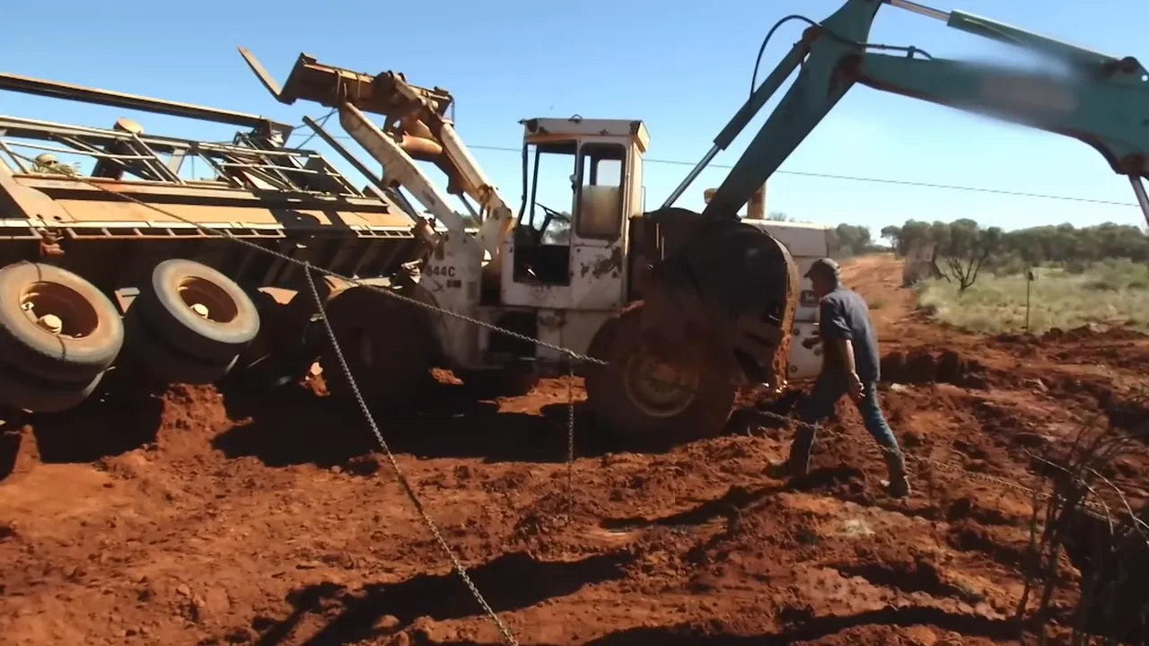 Vehicles rigged to winch the crusher