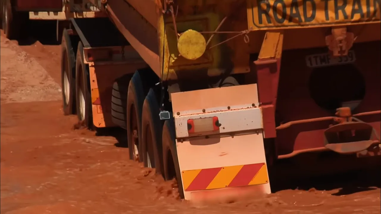 Steve digging and working to free the bogged trailers