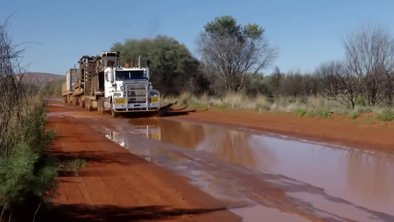 Truck taking a risky shortcut on wet outback track