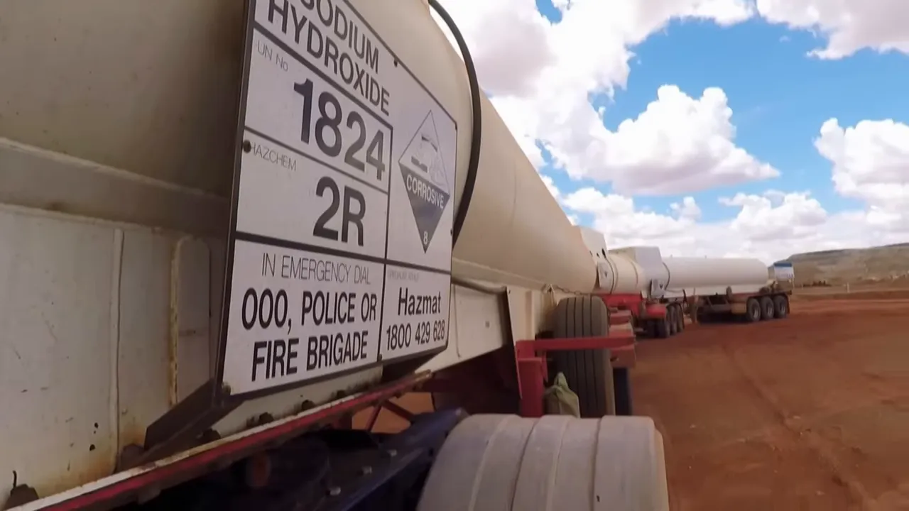 Road train at mine turnoff, dust on the road