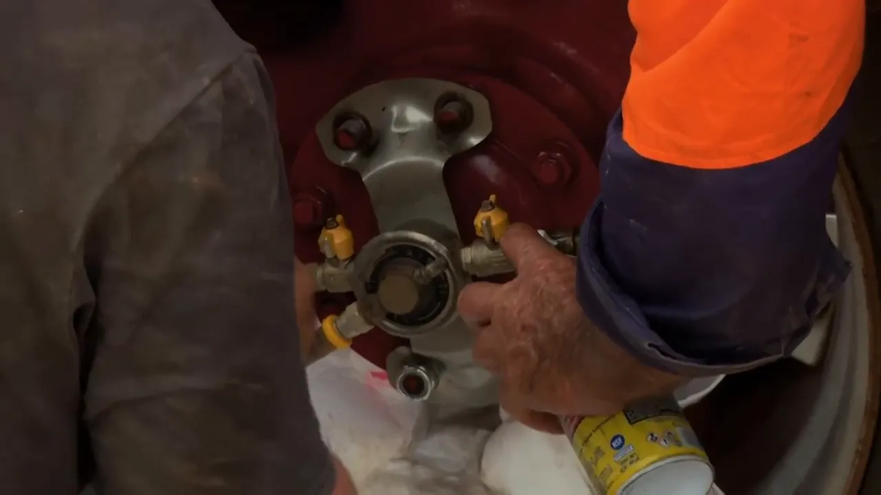 Mechanic inspecting the damaged hub and bearing area