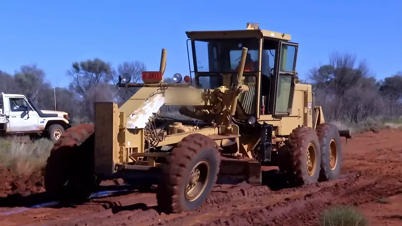 Grader and loader struggling in the saturated mud