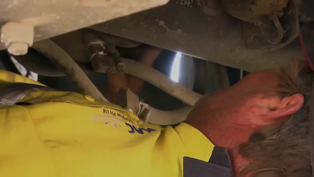 The team working under the trailer to access airbags and suspension