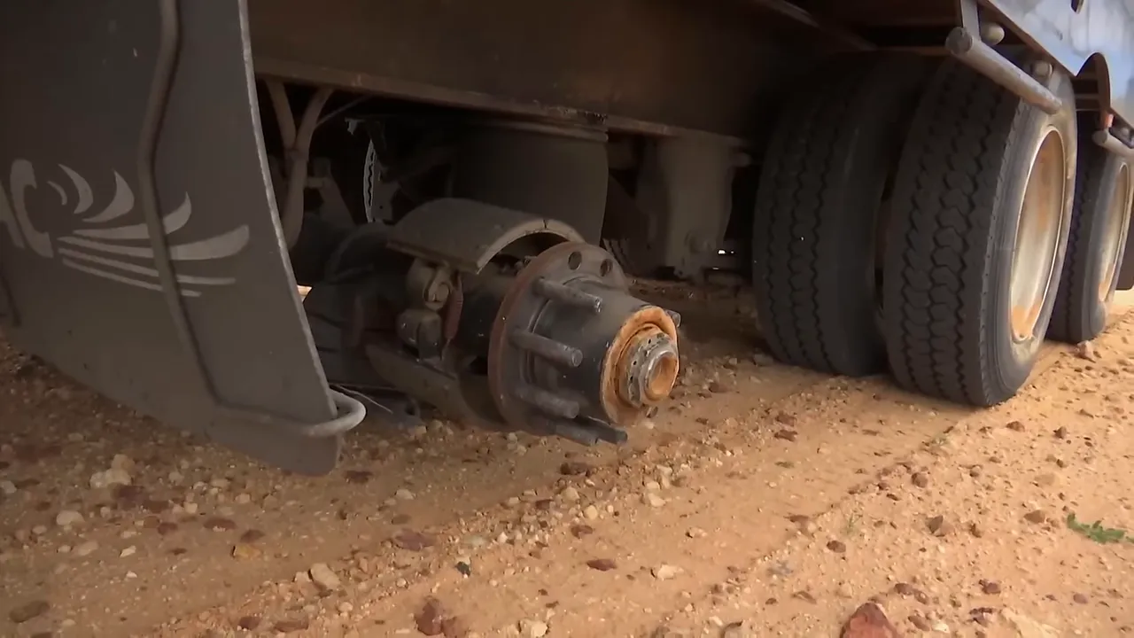 Justin inspecting the damaged wheel area after losing wheels