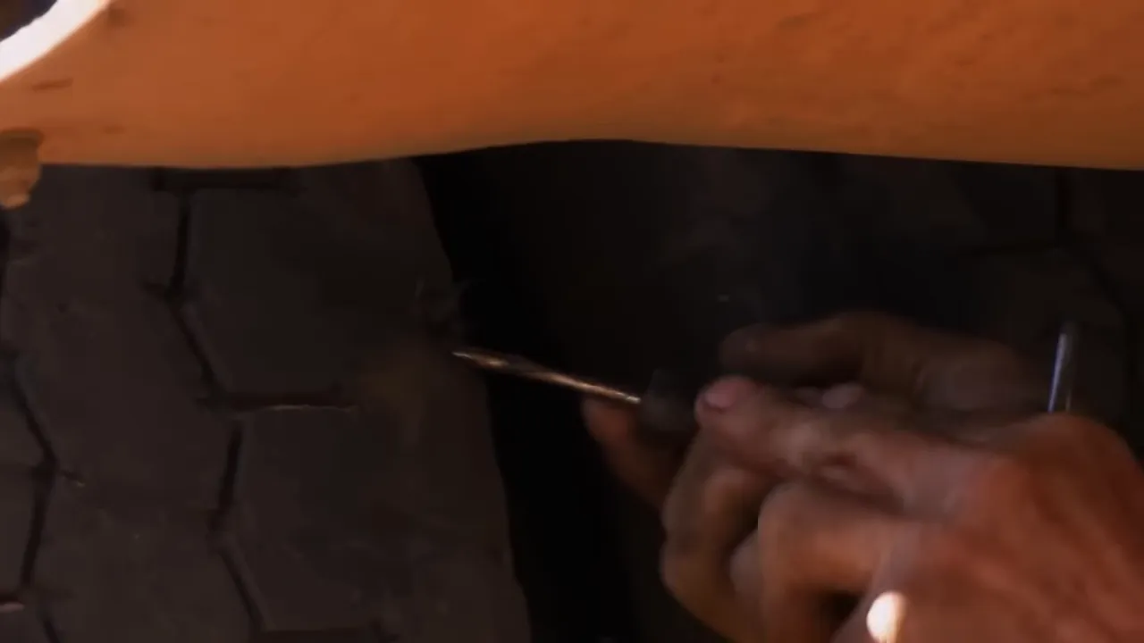 Russell using fire to seat a tyre back onto the rim