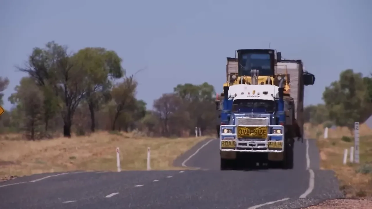 Long road train leaving Alice Springs into the desert