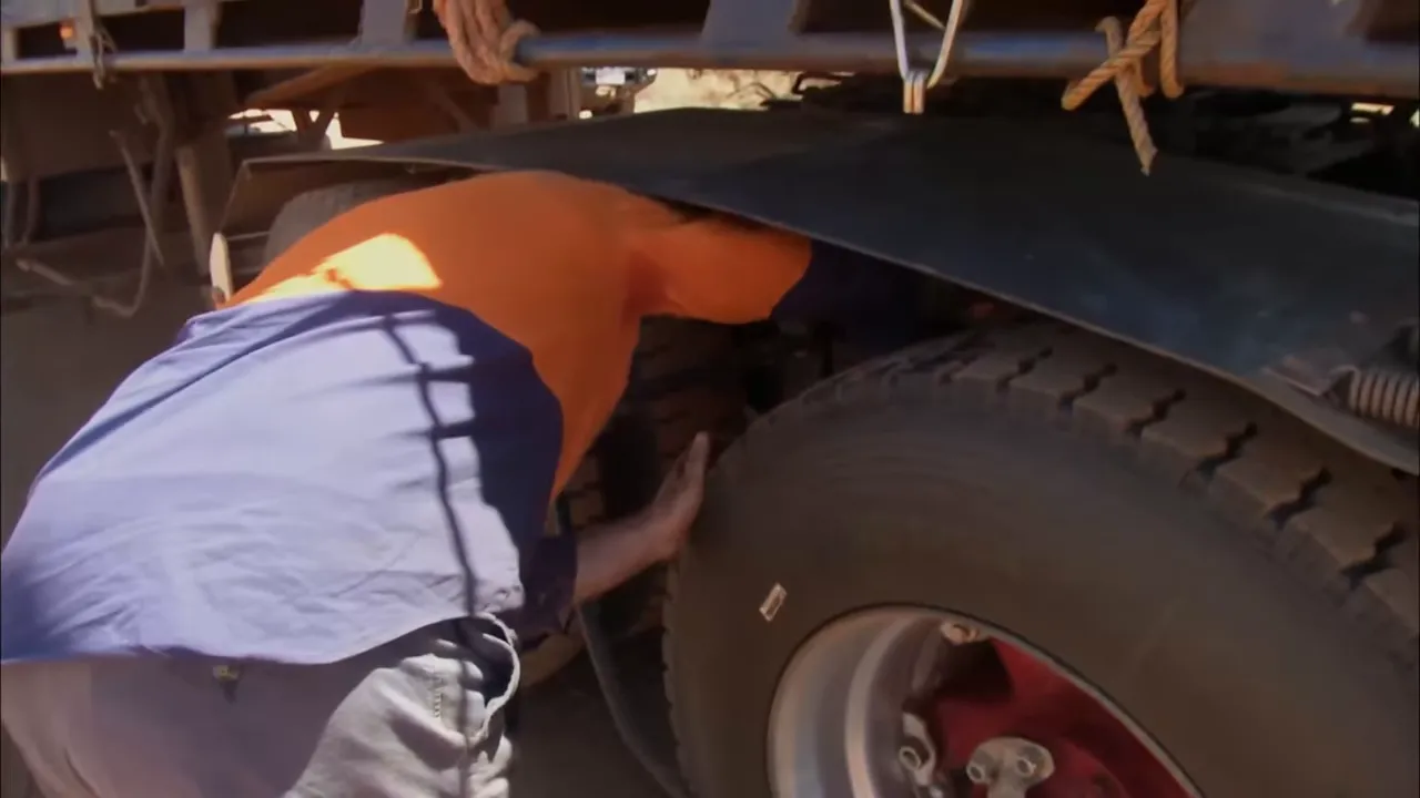 Steve inspects oil on the mudguard and wheel arch