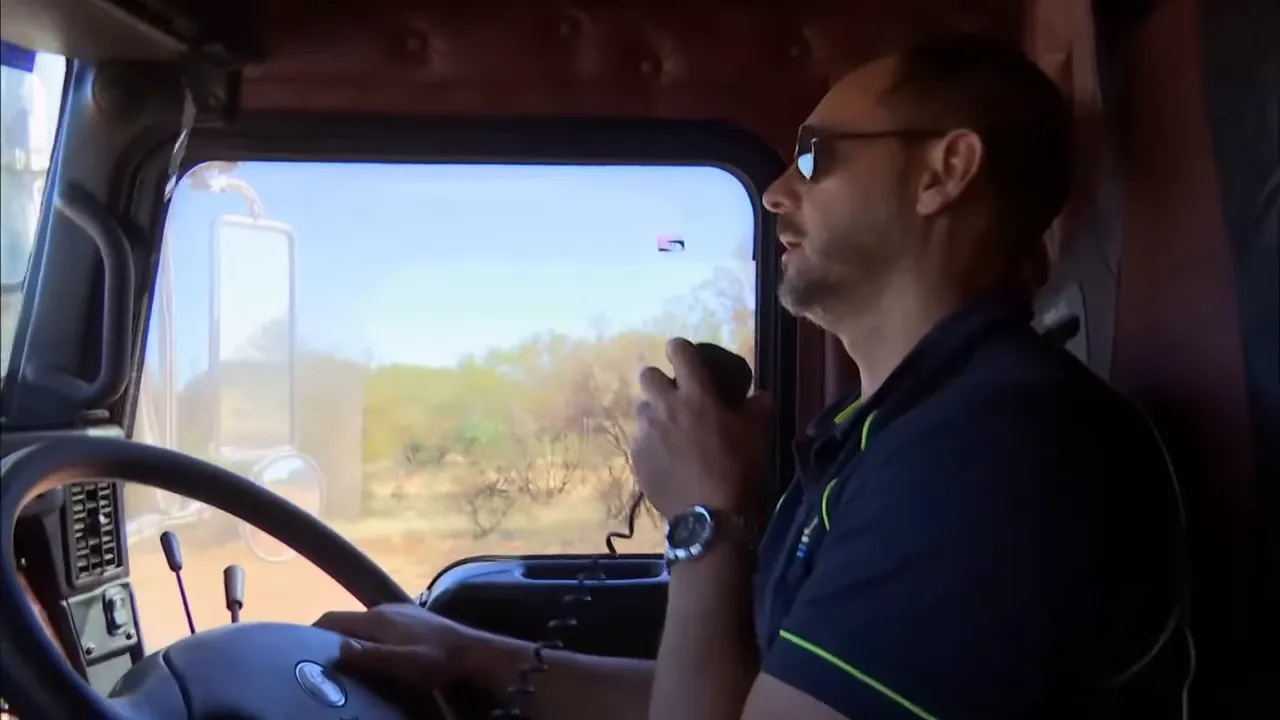 Mark driving on the Tanami Track, deadline pressure visible