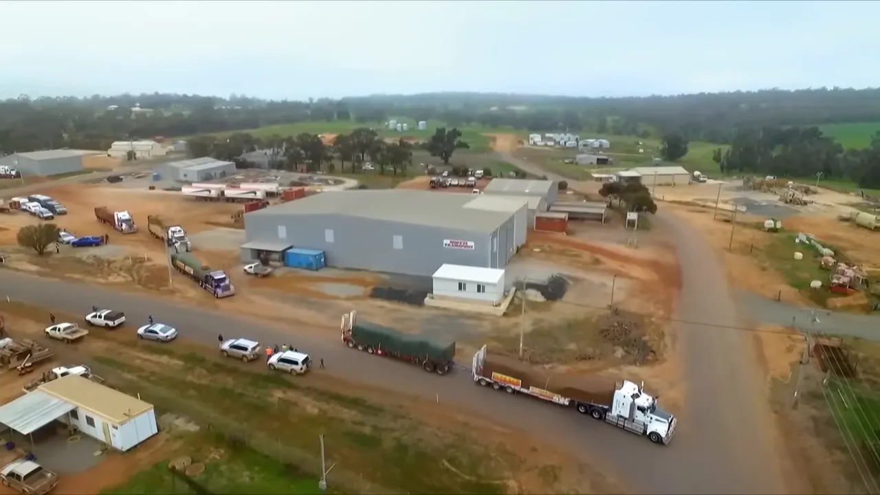 Convoy of trucks departing under blue sky