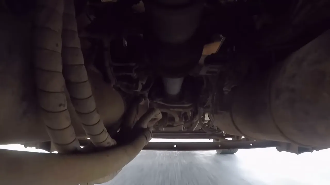 Mechanic inspecting a truck undercarriage