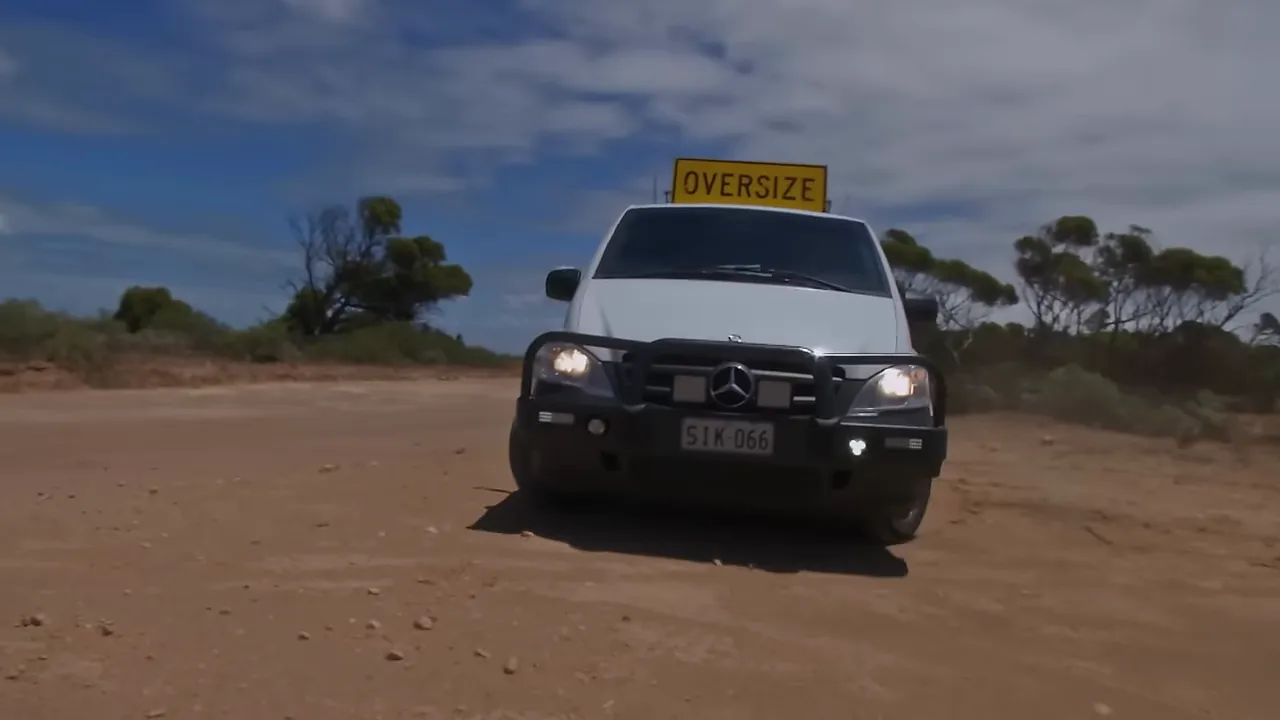 Pilot car inspection to assess a wet dirt bypass before committing the convoy