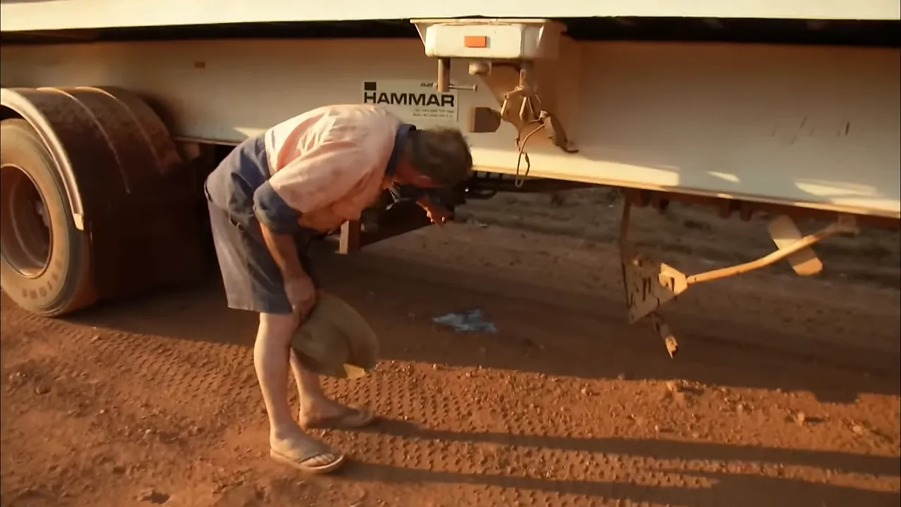 Damaged spare tyre carrier and smashed hydraulic line under the trailer