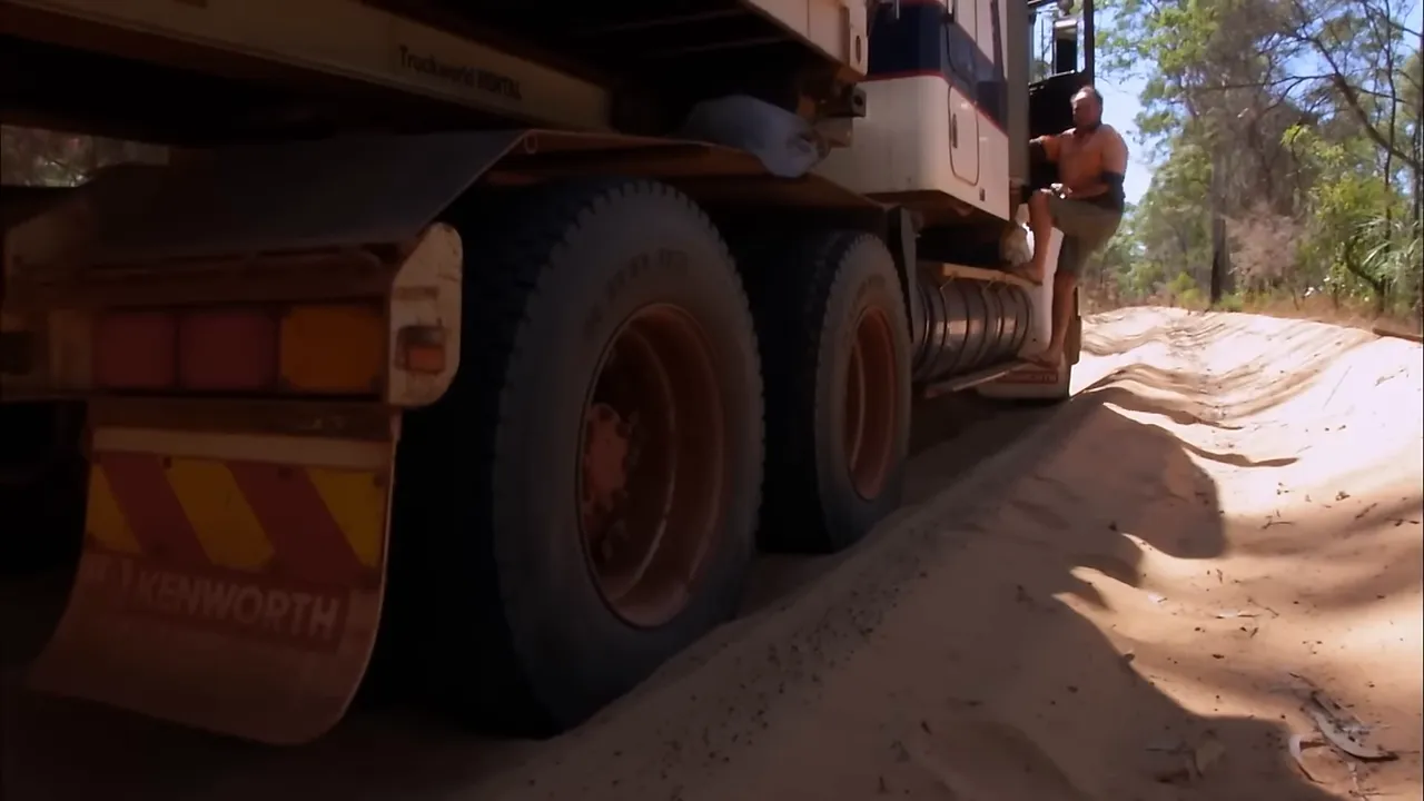 Truck stuck in soft sand; tyre deflation underway