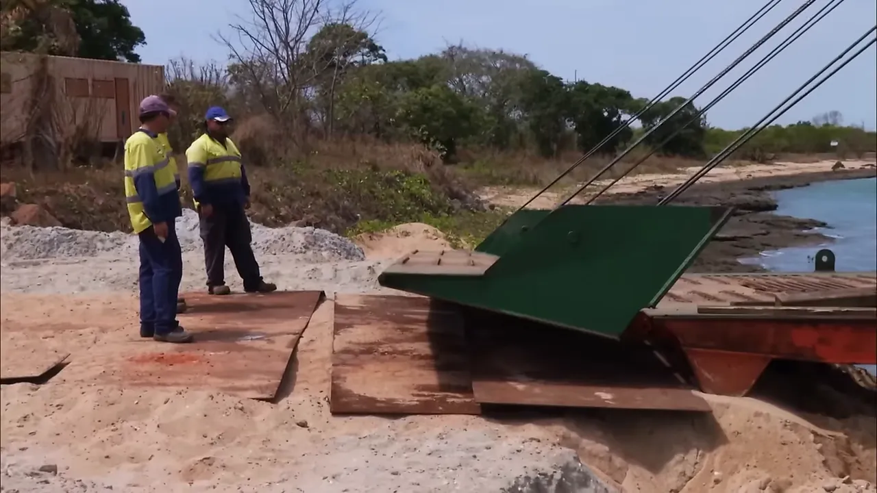 Barge punching into the mud to make the ramp