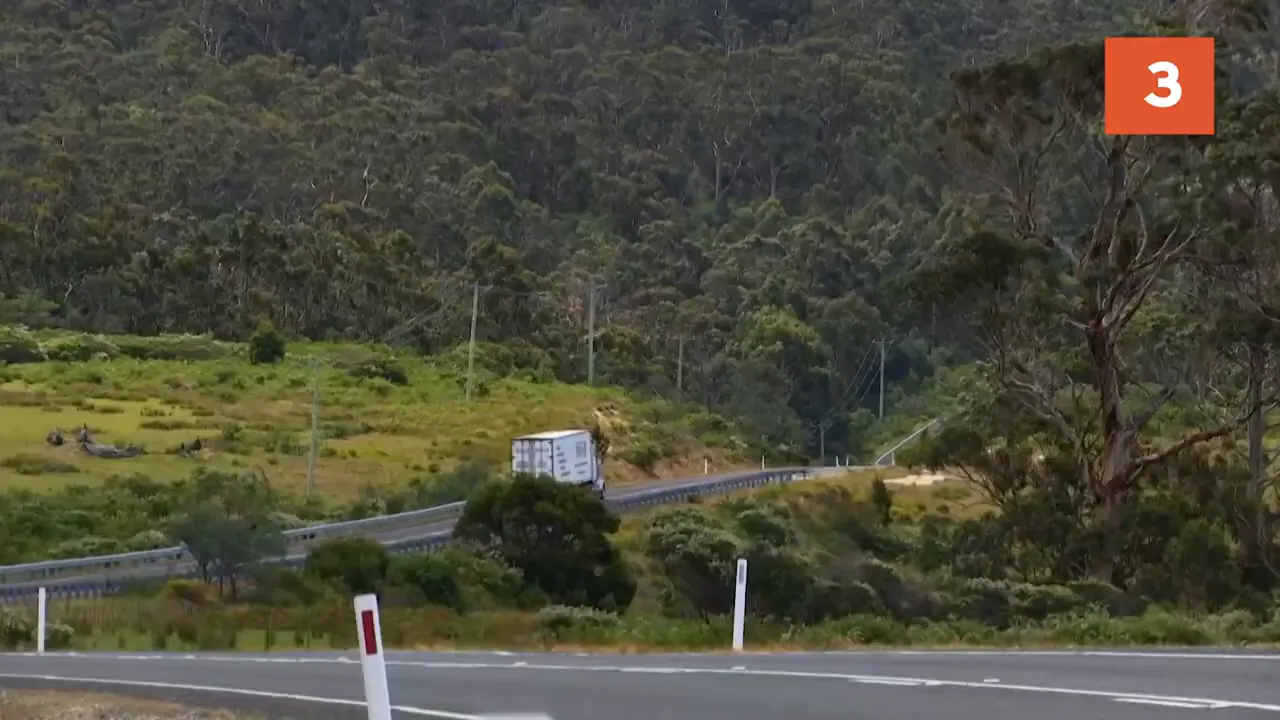 Truck battling heavy crosswinds on mountain pass