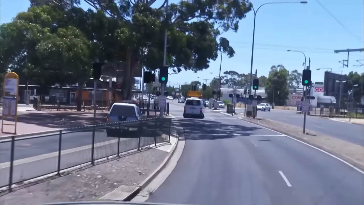 Escort vehicle waiting at a level crossing
