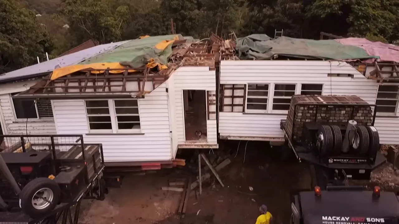 Two truck trailers steering apart as the house sections separate