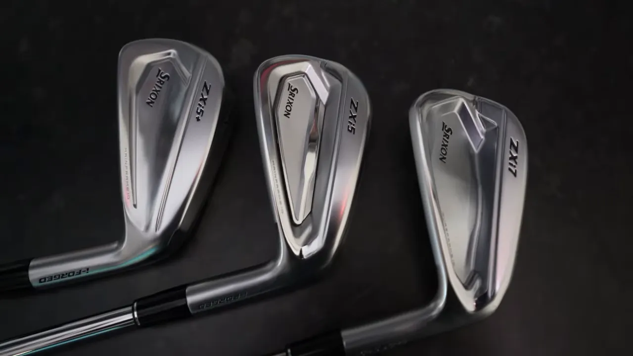 Three Srixon ZXi iron heads arranged on a dark surface