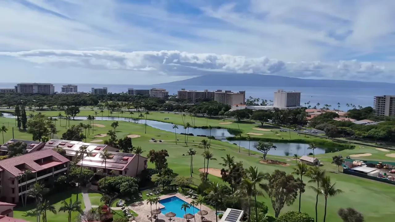 Wide aerial view of Kaanapali showing resort condos, swimming pool, golf course and ocean